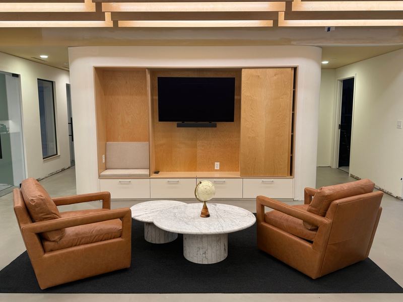 Lounge seating with leather chairs and a built-in TV wall